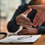 Lawyers shake hands with business people to seal a deal with par