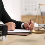 Lawyer working at table in office, selective focus