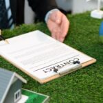 Đặt cọc mua bán nhà đất có cần ra văn phòng công chứng không? businessman-ceo-office-signing-environmental-regulation-agreement-save-earth-with-sustainable-energy-utilization-co2-reduction-greener-future-quaint_31965-269809